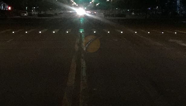 Solar road studs with spacing at road intersection at night, improving road safety